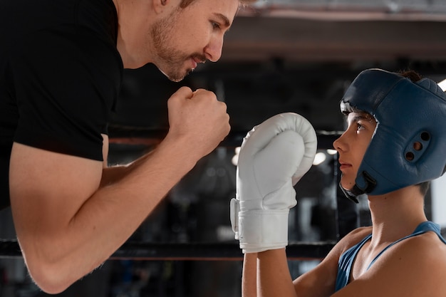 Free photo side view young boy boxing