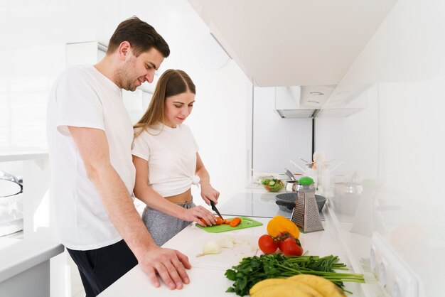 Side view young couple in kitchen