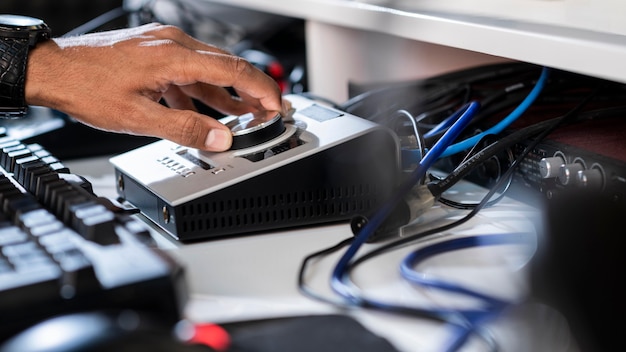 Free photo side view young man hands working at a radio station