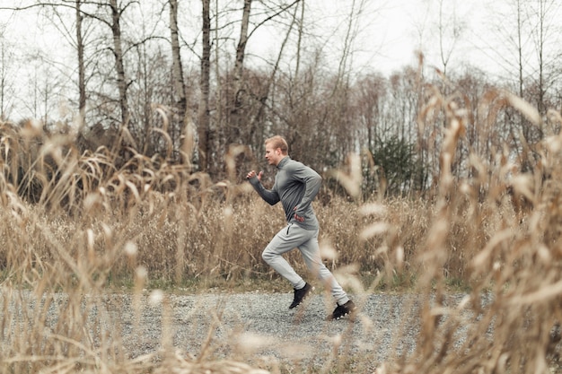 Free Photo side view of young man running in field