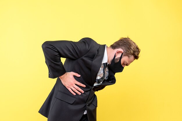 Side view of young man suffering from pain