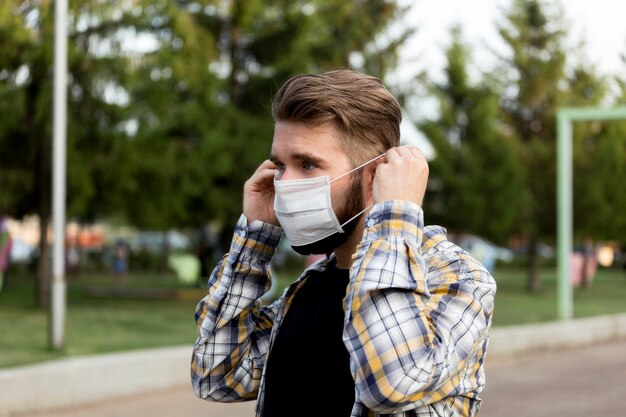 Side view young man wearing face mask