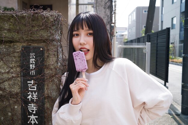 Side view young woman holding tasty ice cream