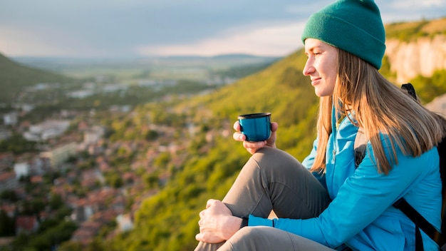 Side view young woman with beanie enjoying trip