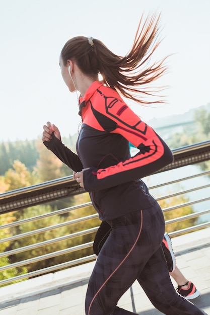 Side view of young women running