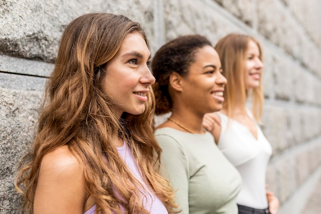 Free photo sideways beautiful female friends looking away