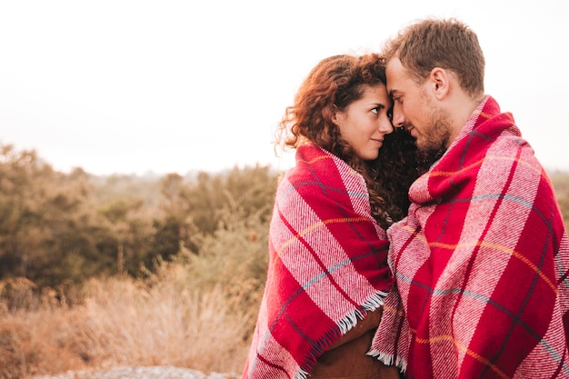 Free photo sideways happy couple having a tenderness moment