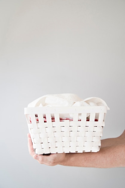 Sideways person holding laundry basket