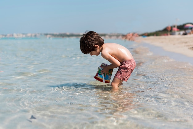 Sideways shot of a kid playing in water