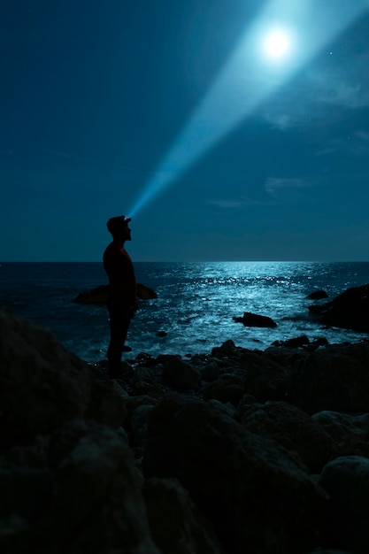 Sideways silhouette of a man looking at the sky