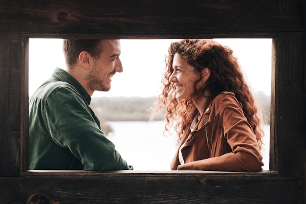 Free Photo sideways smiling couple looking at each other