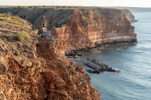 Sideways woman enjoying the view with copy space