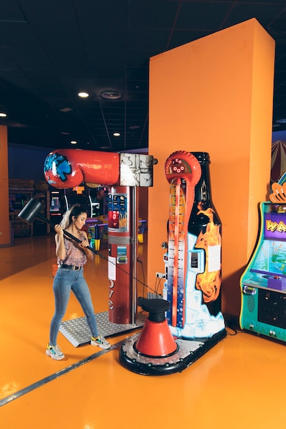 Free Photo sideways woman playing arcade game