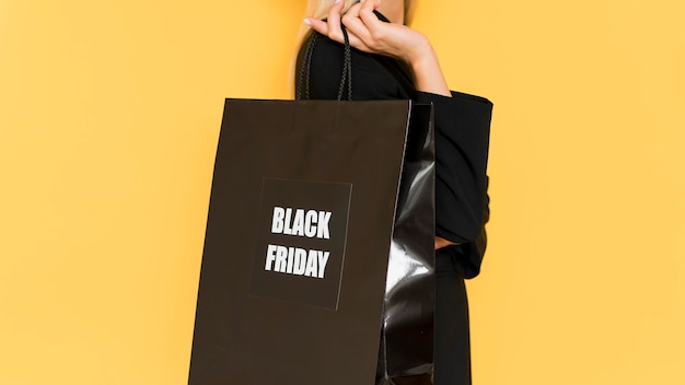 Free Photo sidways woman holding shopping black for black friday