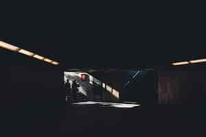 Free photo silhoette of two people entering a dark shady underground building