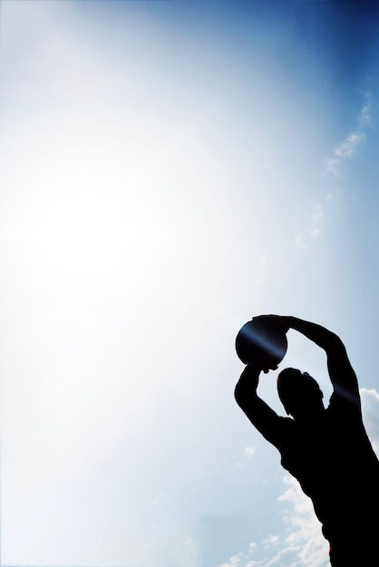 Silhouette of basketball player with sun effect