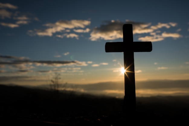 Silhouette of catholic cross and sunrise