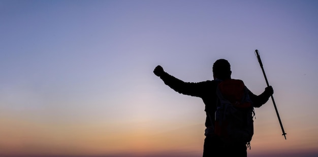 Free Photo silhouette of cheering hiking man open arms to the sunrise stand on mountain with copy space travel lifestyle wanderlust adventure concept summer vacations outdoor