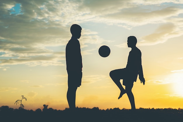 Free photo silhouette of children play soccer football