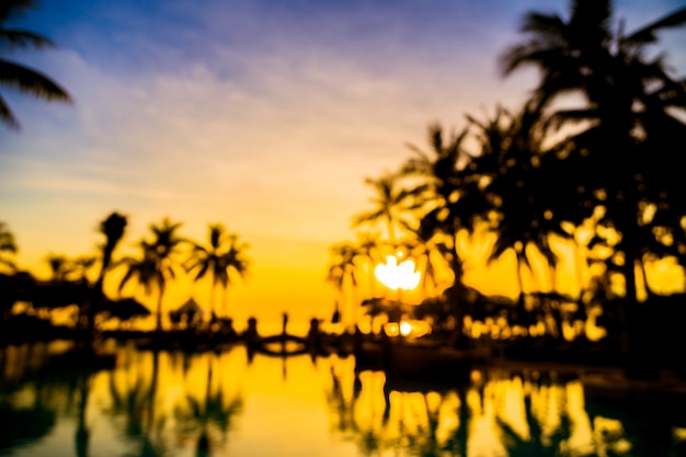 Silhouette coconut palm tree around swimming pool