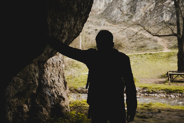 Free Photo silhouette of hiker in a cave