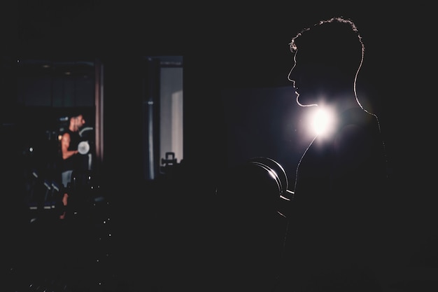 Free Photo silhouette of man in gym