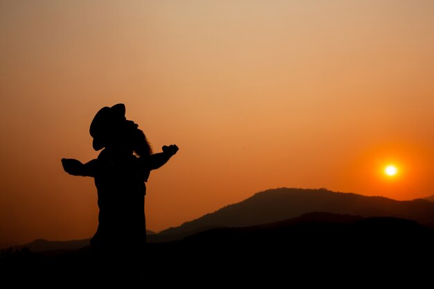 Silhouette of a man with outstretched arms.