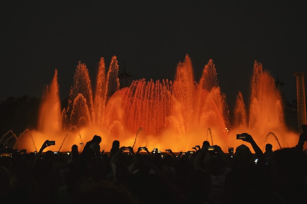 Silhouette photography of people in front of water fountain