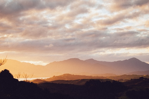 Silhouette of a range of beautiful mountains under the breathtaking sunset sky