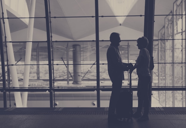 Free photo silhouette senior couple traveling airport scene