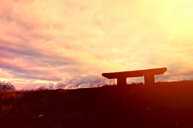 Silhouette at sunset wooden table