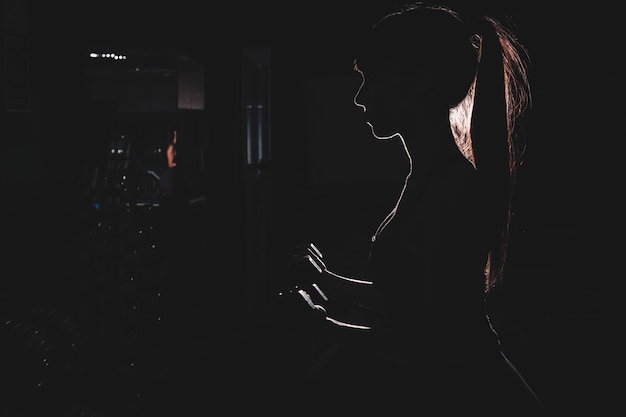 Silhouette of woman in gym