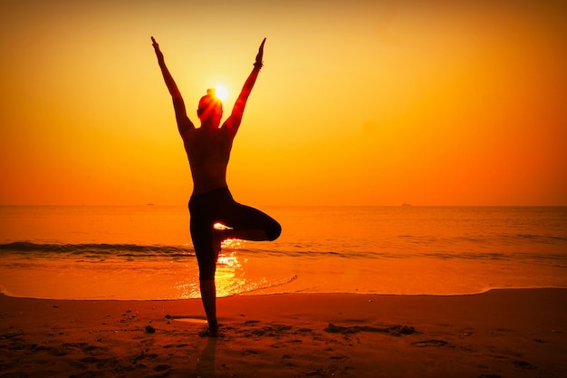 Silhouette of woman with sun behind