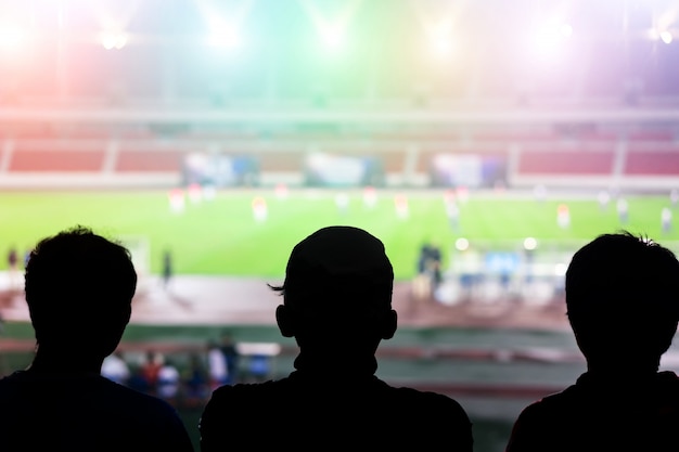 Silhouettes in a football stadium