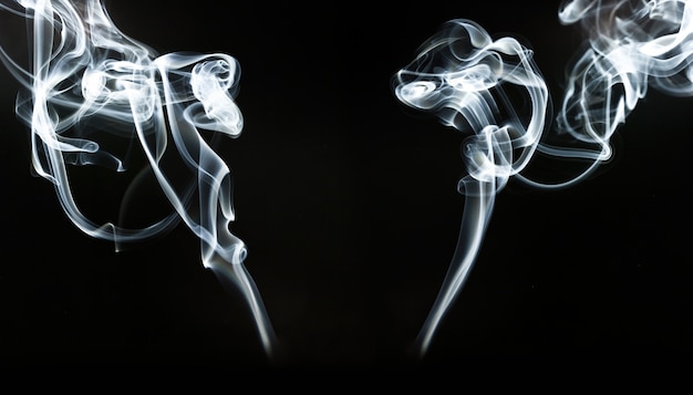 Free Photo silhouettes of white smoke on black background