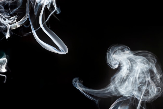 Free photo silhouettes of white smoke in motion