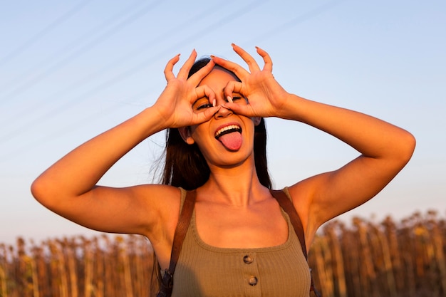 Free Photo silly woman posing outdoors in sunset