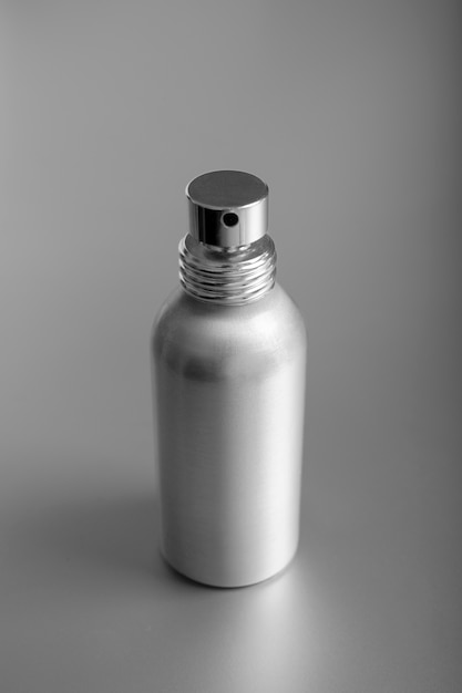 Free Photo silver aesthetic wallpaper with bottle