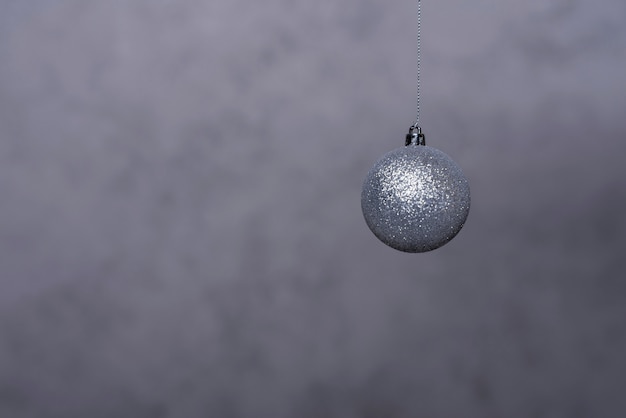 Silver Christmas ball on thread