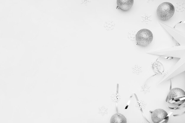 Silver Christmas ornaments on white table