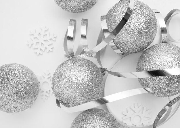 Silver Christmas ornaments on white table