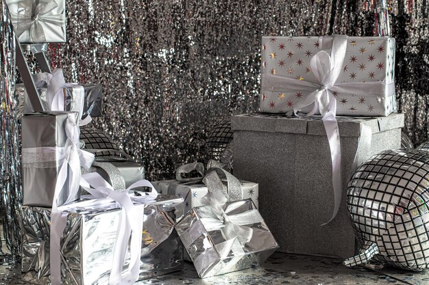 Silver festive christmas boxes on a shiny background