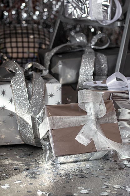 Free photo silver festive christmas boxes on a shiny background