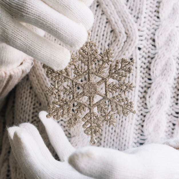 Free Photo silver snowflake in hands 