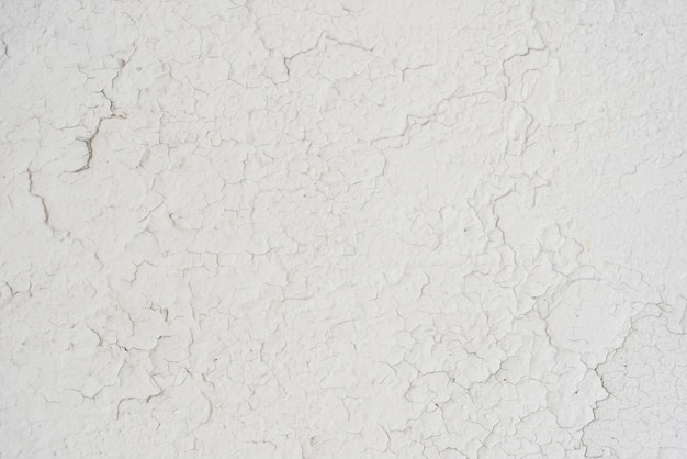 Simple white wall with cracks