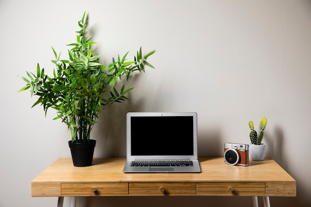 Simple wooden desk with gray laptop