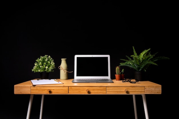 Simple wooden desk with grey laptop