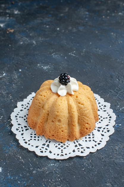 simple yummy cake with cream and blackberry on dark desk