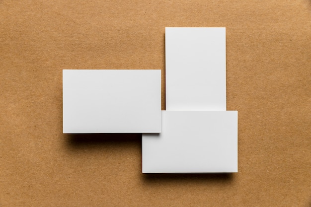 Free photo simplistic white envelopes on wooden background