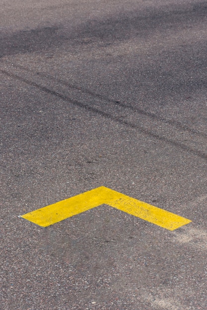 Simplistic yellow arrow on the street